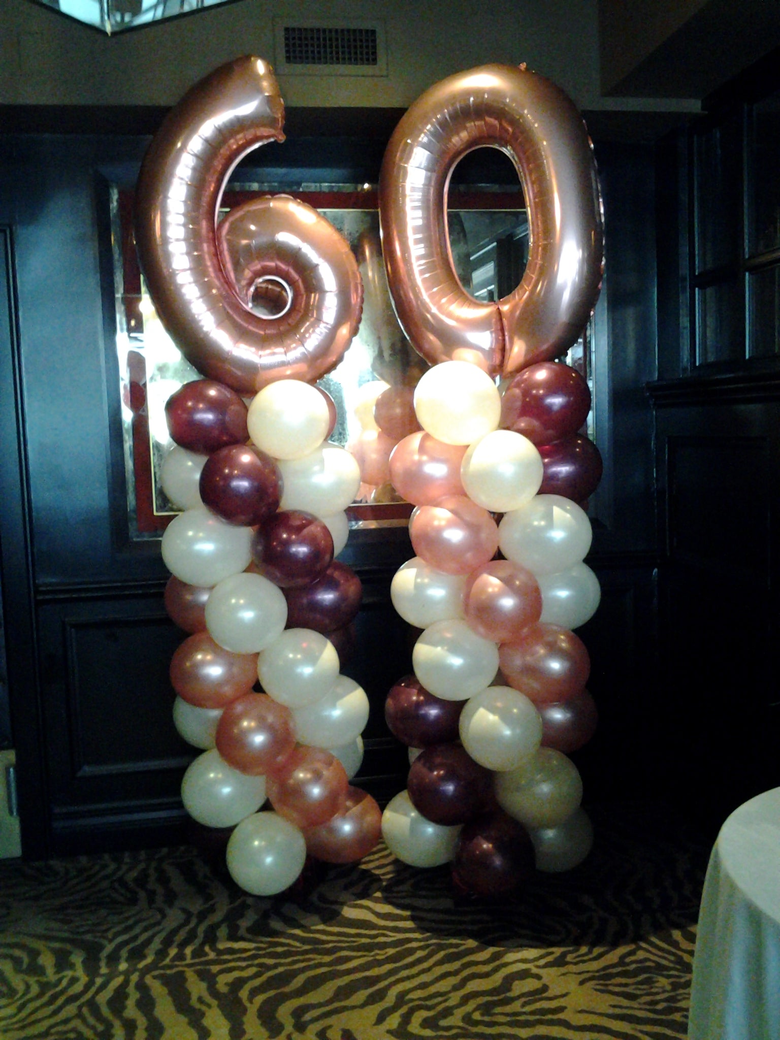 two 6 ft balloon columns with number 60 topper for birthday party decoration