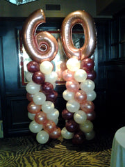 two 6 ft balloon columns with number 60 topper for birthday party decoration