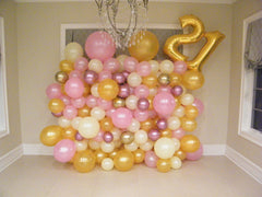 colorful organic balloon wall backdrop with number balloons for age celebration