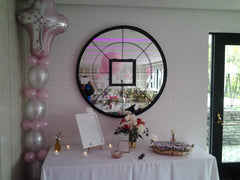 Religious balloon decor centerpiece featuring vibrant latex balloons and Mylar cross