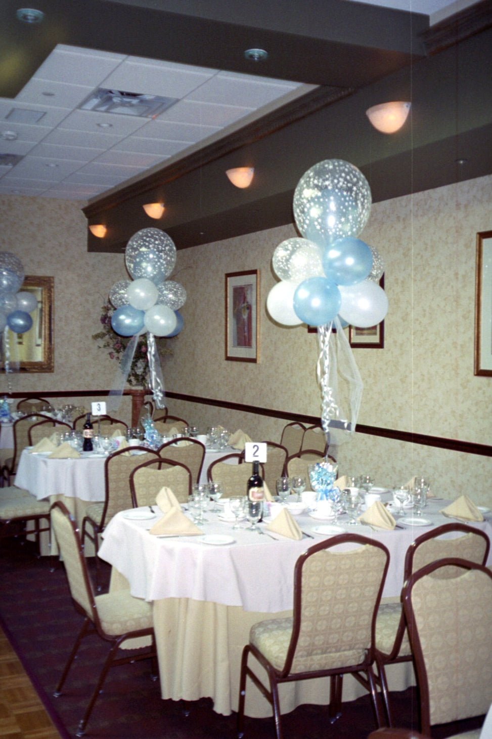 Fantasy Cloud Centerpiece with white, blue, and clear bubble balloons on foil weight