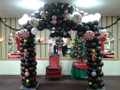 Festive balloon arch with gingerbread man and candy balloons for holiday décor