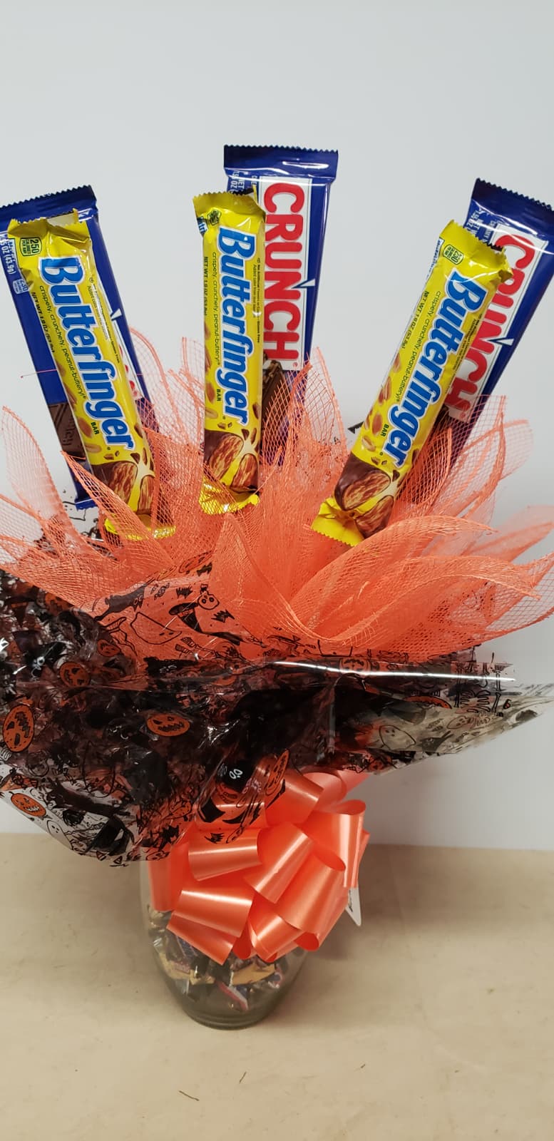 Halloween candy bouquet in keepsake glass jar with Crunch and Butterfinger candy bars and mini candy assortment