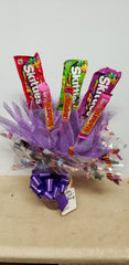Halloween candy bouquet in keepsake glass jar with Skittles and Starburst candy bars and mini candy assortment