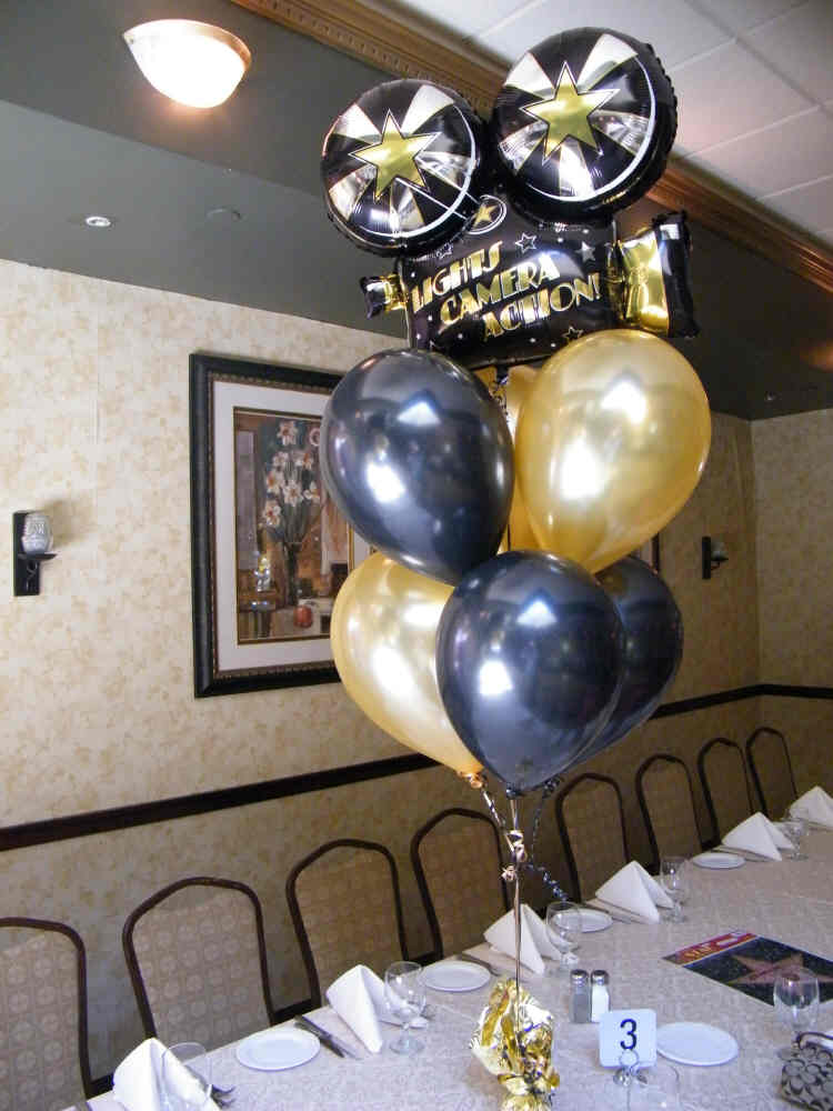 Black and gold Hollywood balloon centerpiece with movie camera mylar, 6 latex balloons, tabletop decor
