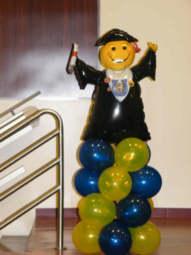 Graduation balloon column with colorful stacked balloons and large grad topper