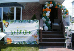 jungle themed organic balloon l shape arch with flowers for parties