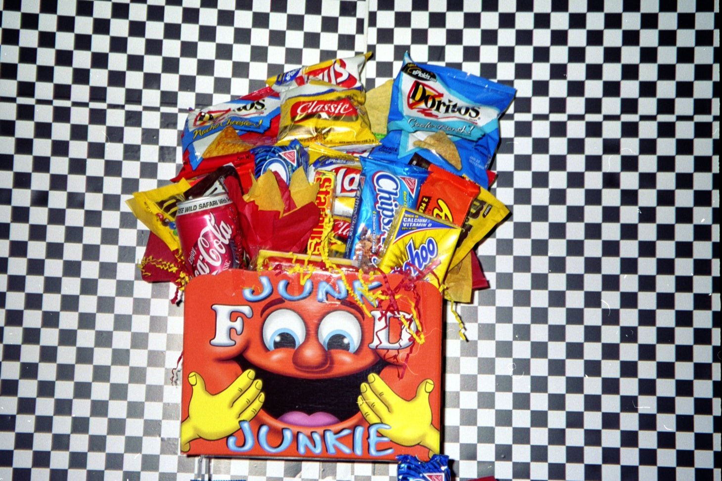 junk food gift basket with chips, candy, and soda