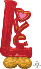 Large red and gold “LOVE” AirLoon balloon display standing on the floor indoors