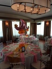 Balloon centerpiece with colorful latex base and large moon and star foil topper
