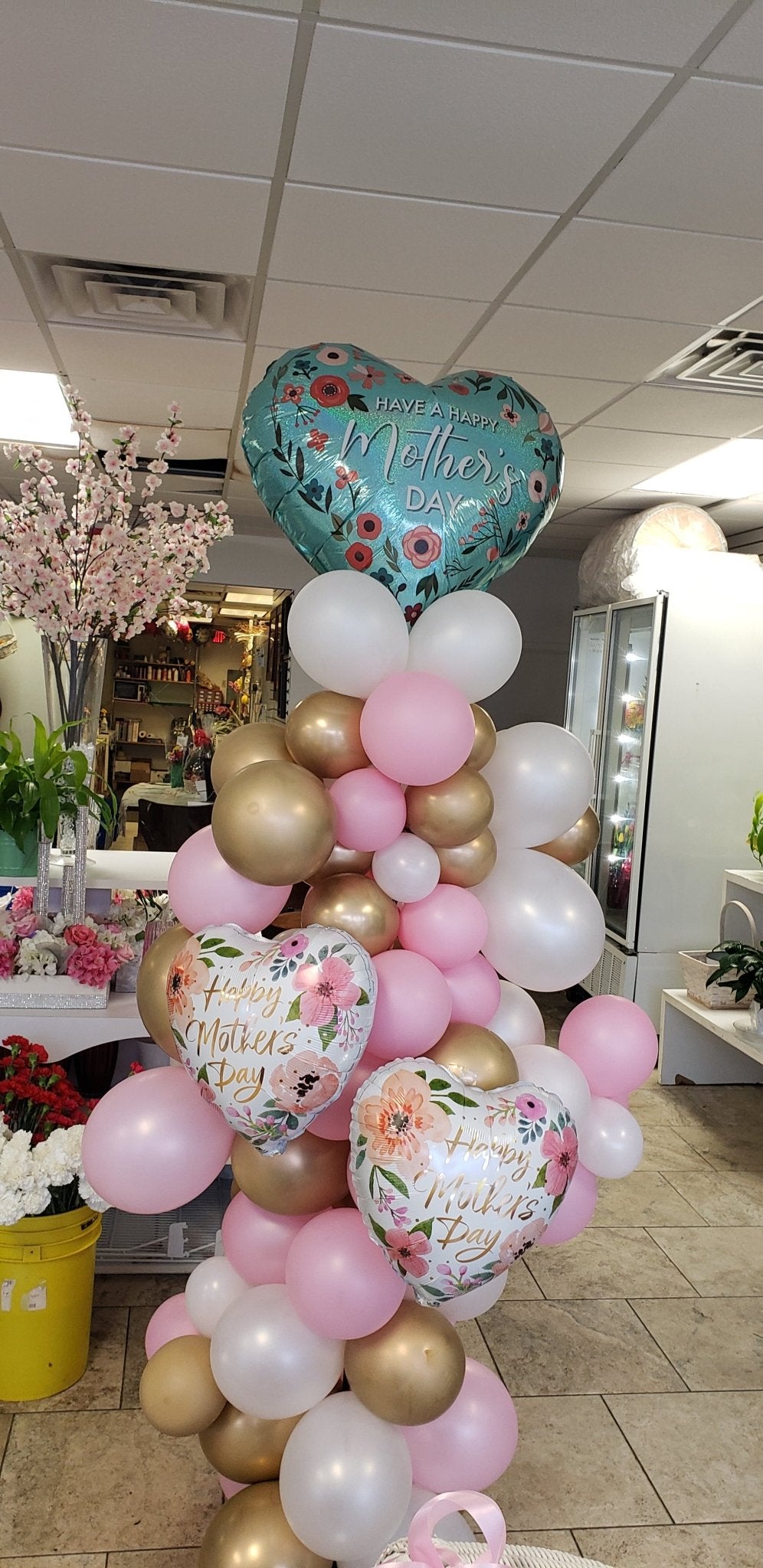 Mother’s Day organic balloon column featuring pastel and pink balloons, approximately 7-8 feet tall