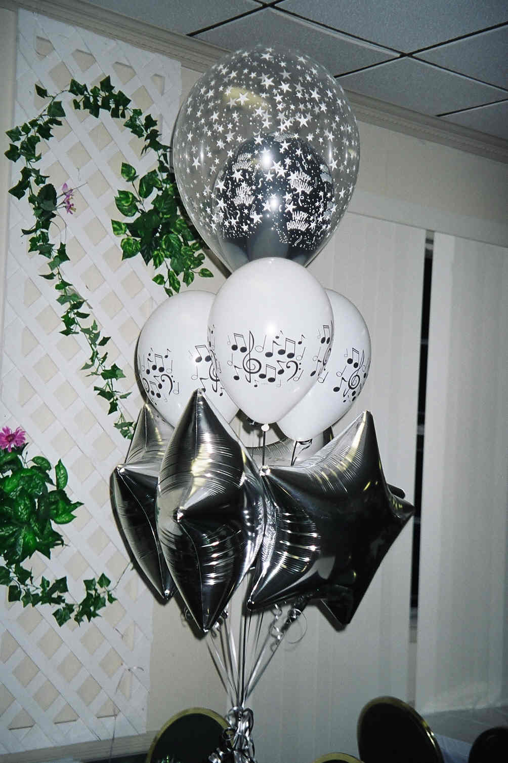 music under the stars balloon bouquet with silver mylar stars, music note latex, and clear star balloon