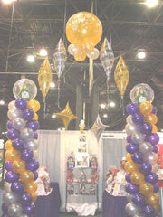 Colorful New Year’s Eve balloon arch with festive mylar balloons and balloon columns