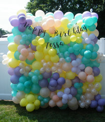 Colorful organic balloon wall backdrop for parties, weddings, and events