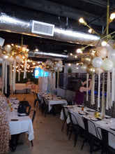 Colorful organic balloon cloud sculpture with streamers, whimsical party décor