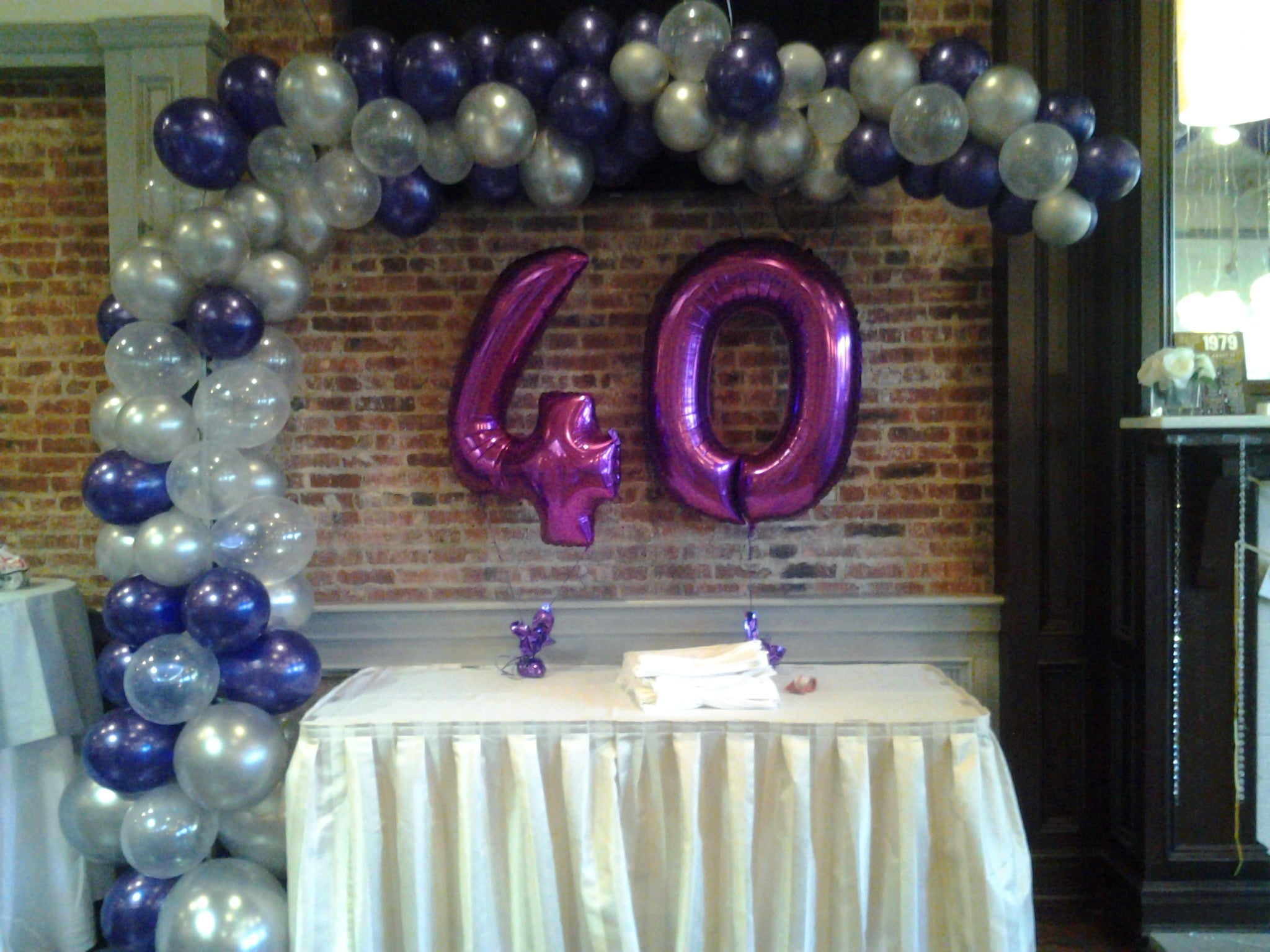 organic l shape balloon arch with number mylar centerpiece for birthday decor