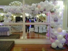Colorful organic L-shape balloon arch décor for parties and events