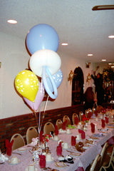 Colorful pacifier centerpiece balloon with three baby-print latex balloons