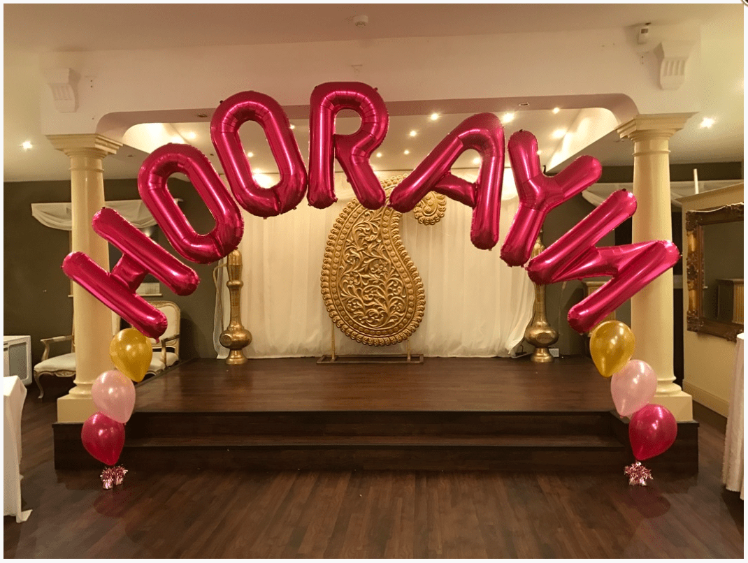 Colorful latex balloon arch with custom mylar name letters centerpiece