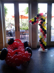 Colorful race car-themed balloon arrangement for birthdays or events