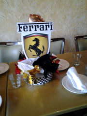 Table décor featuring a race car logo and mini balloon details