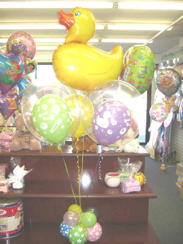 Rubber Duckie balloon centerpiece with colorful latex base and large duck mylar topper