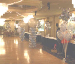 snow-themed balloon column with large clear bubble topper and frosted latex balloons