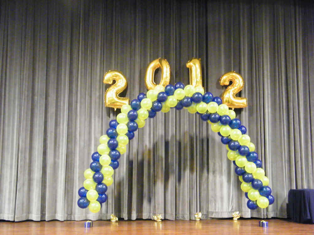 Spiral latex balloon arch with year topper decoration