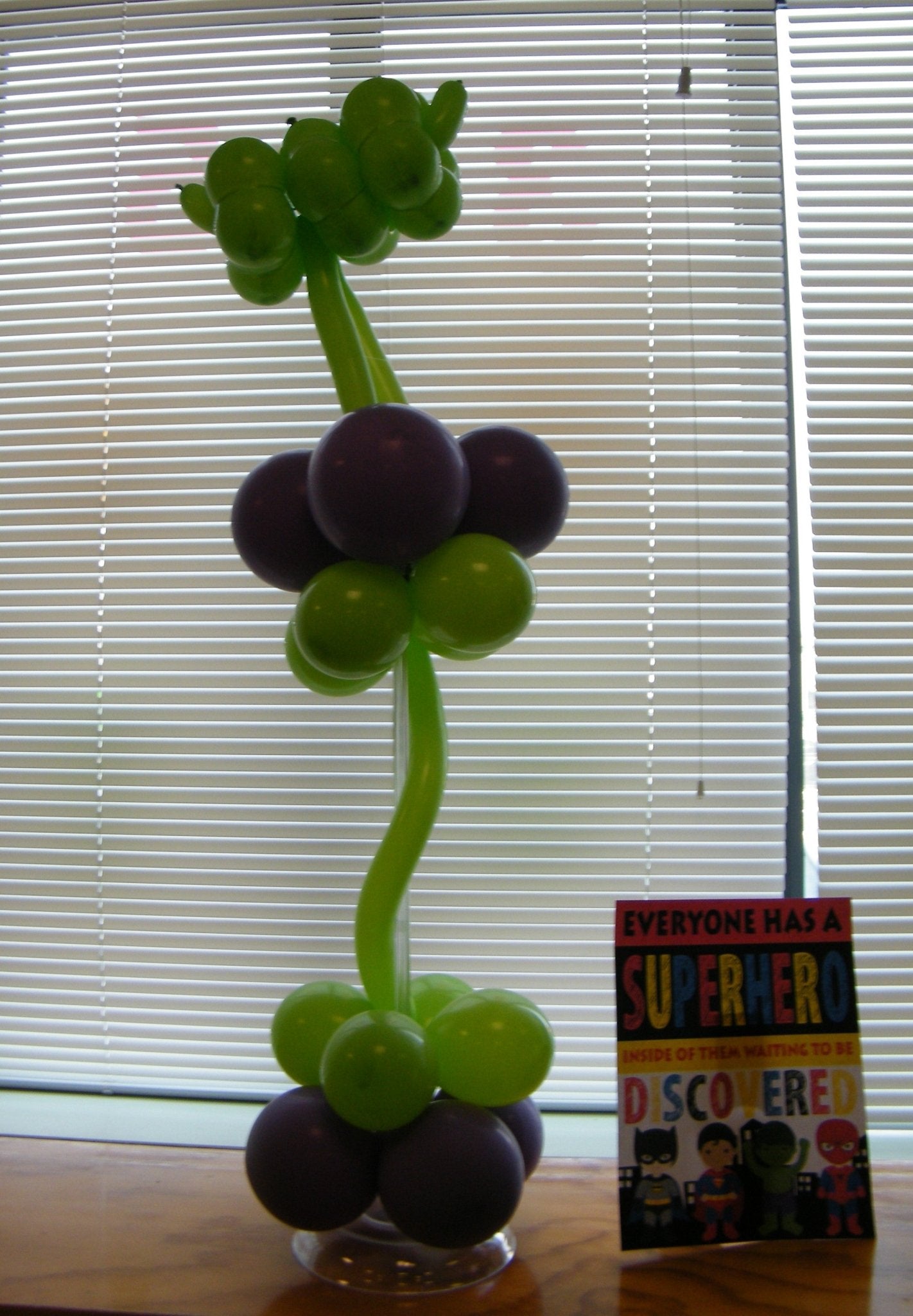 Colorful superhero balloon sculpture, vibrant party décor, fun and life-sized