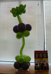 Colorful superhero balloon sculpture, vibrant party décor, fun and life-sized