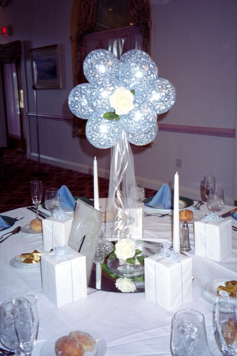 Victorian garden balloon centerpiece with 5 Inch latex balloons, silk rose, tulle, and ribbon on acrylic base