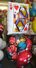 Casino Royale balloon bouquet with oversized playing card balloon, dice balloons, and casino-themed accents