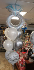 Engagement balloon bouquet with large diamond ring balloon, white and silver latex, and engagement message balloons