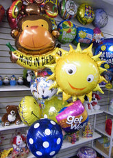 Hang in There Get Well balloon bouquet with sloth balloon, sun balloon, Get Well Soon balloons, and colorful latex balloons