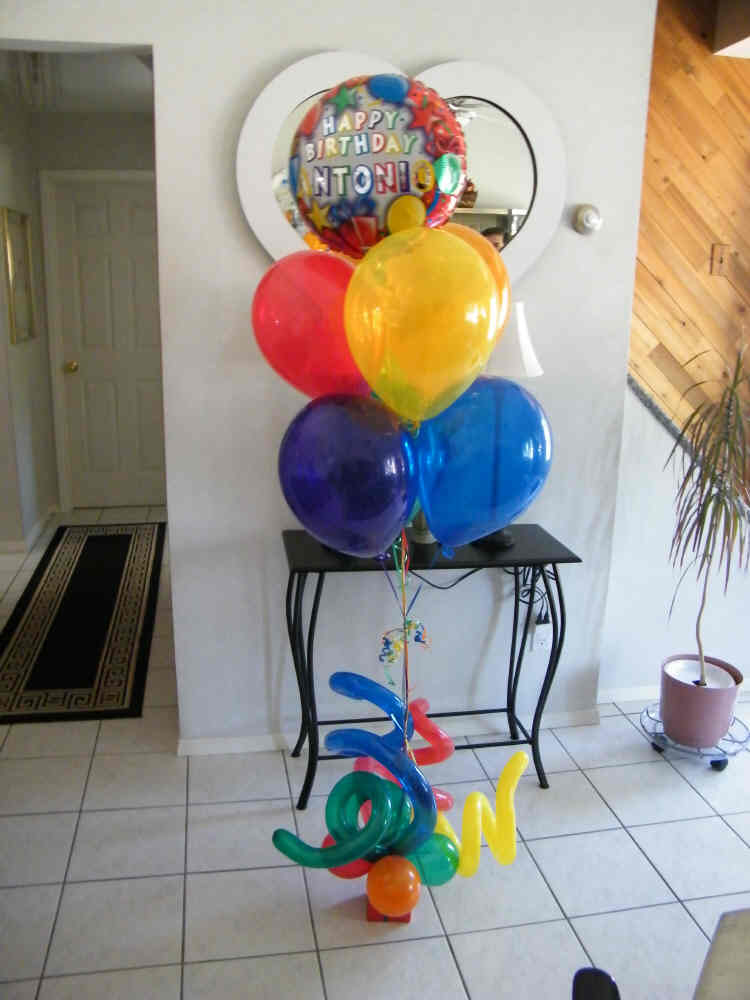 Happy Birthday balloon bouquet with colorful latex balloons and curly Q accents in gift box base