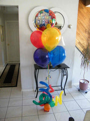 Happy Birthday balloon bouquet with colorful latex balloons and curly Q accents in gift box base
