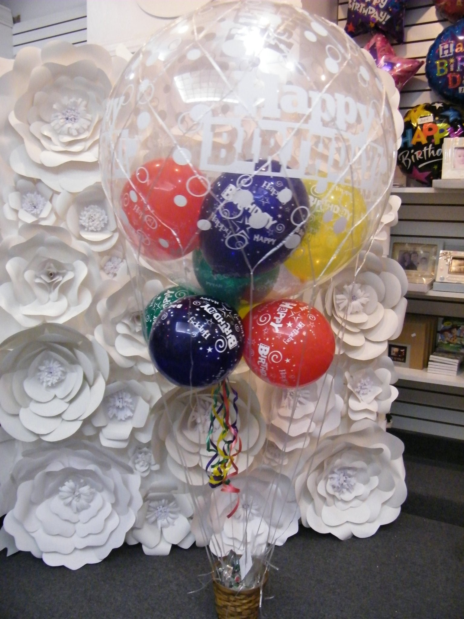 Happy Birthday big balloon bouquet with giant clear balloon, colorful latex balloons, and candy basket hot air balloon design