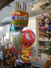 Champagne celebration birthday balloon bouquet with bottle, glass, and happy birthday balloons