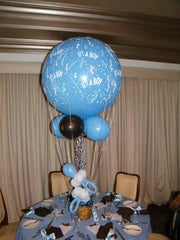 Hot air balloon style bouquet with jumbo blue or pink balloon, baby rattle balloon, and basket of Hershey’s Kisses