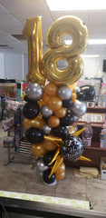 Organic balloon column with milestone number balloons on top in customizable colors