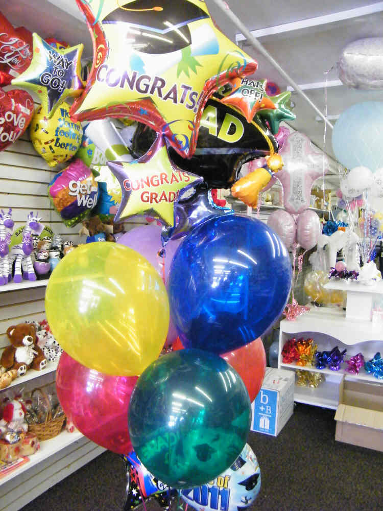 Super size graduate balloon bouquet with jumbo mylar balloons, latex balloons, and candy weight