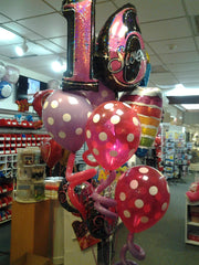 Sweet Sixteen balloon bouquet with jumbo Sweet 16 balloon, polka dot balloons, curly accents, rainbow cake balloon, and birthday mylars