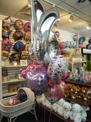 Sweet Sixteen princess balloon bouquet with large number 16 and Happy Birthday balloons