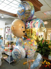 New baby balloon bouquet with giant stork balloon, jumbo new baby balloons, teddy bear, and welcome baby designs