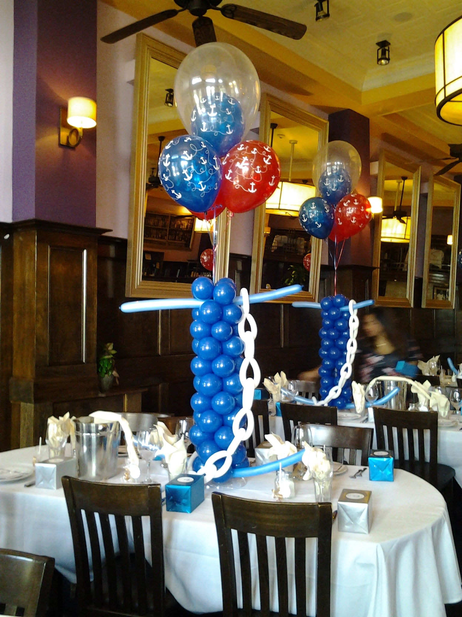 Large balloon anchor centerpiece with nautical theme and latex balloon topper