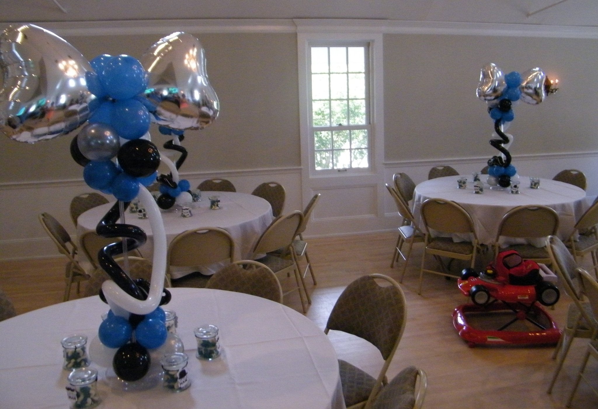Bow tie themed balloon centerpiece with curly Q latex balloons and heart-shaped mylar topper for party decor