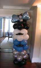 Balloon column with vibrant latex balloons and large mylar heart accent on top