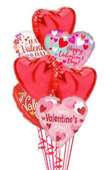 Valentine’s Day balloon bouquet with 18-inch heart-shaped mylar balloons in pink and red shades, arranged on a pink weight