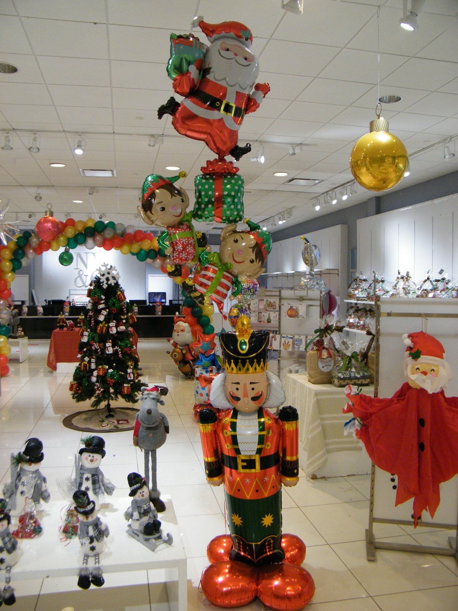 Holiday Nutcracker Balloon Bouquet featuring a 4ft Nutcracker AirLoonz with Santa, presents, and elf balloons