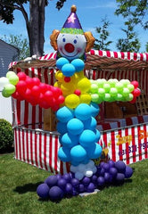 Large colorful clown balloon sculpture with oversized mylar top hat
